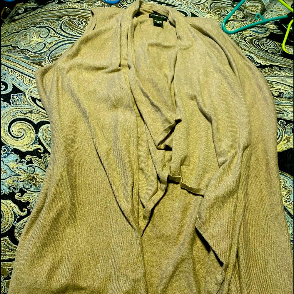 Cream color fairly used sleeveless sweater.